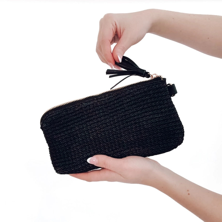 Black raffia clutch wristlet with card holder and detachable strap.