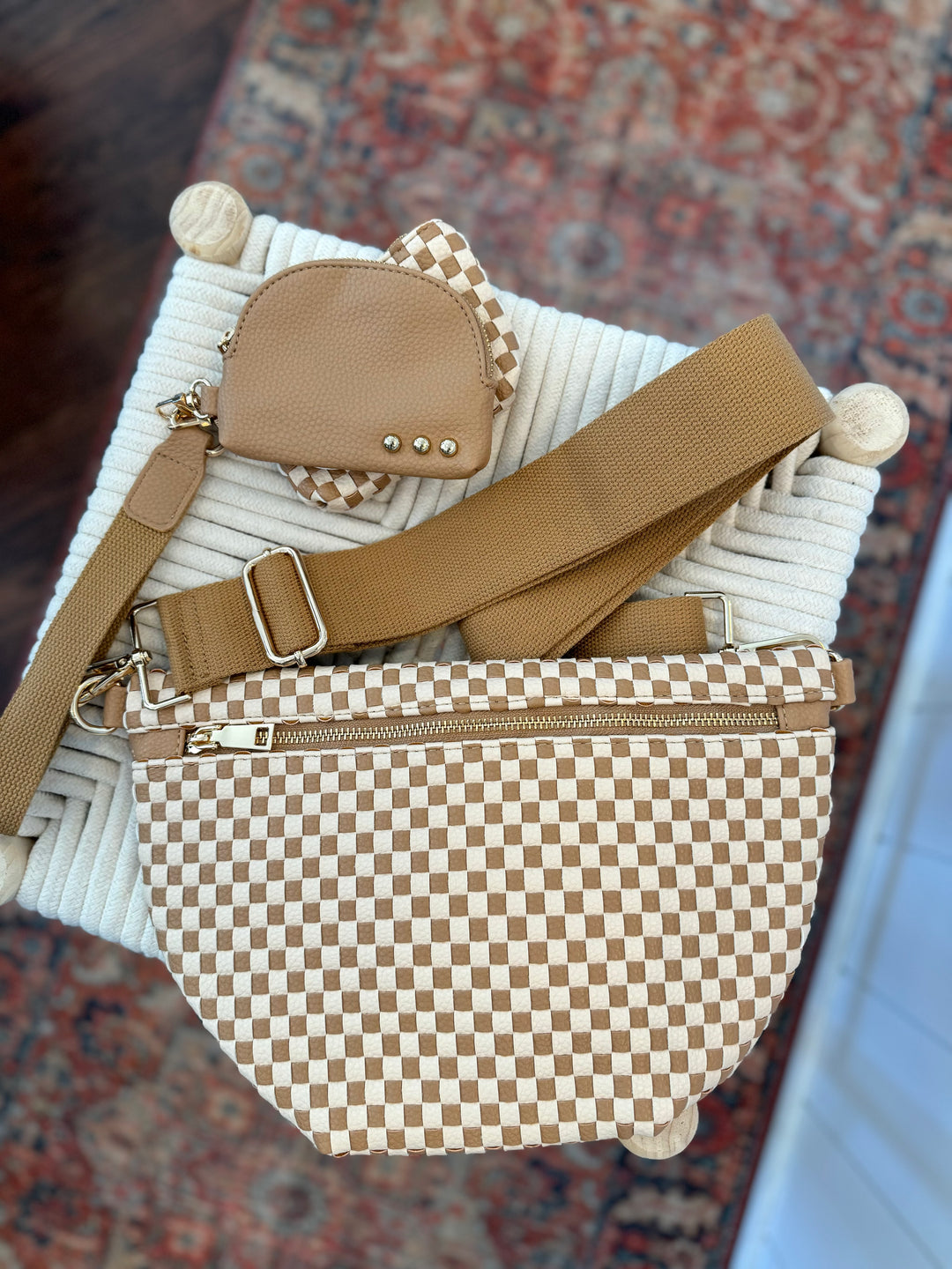 Close-up of checkered woven texture on Maddox Bum Bag in neutral tones pictured with Wonderlust Woven Dual Pouch Wristlet in checkered tan pattern.