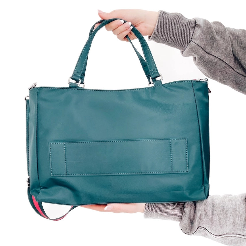 Back view of the teal colored Nina Nylon Tote Bag with exterior zipper pocket, adjustable strap, and interior compartments for everyday convenience.