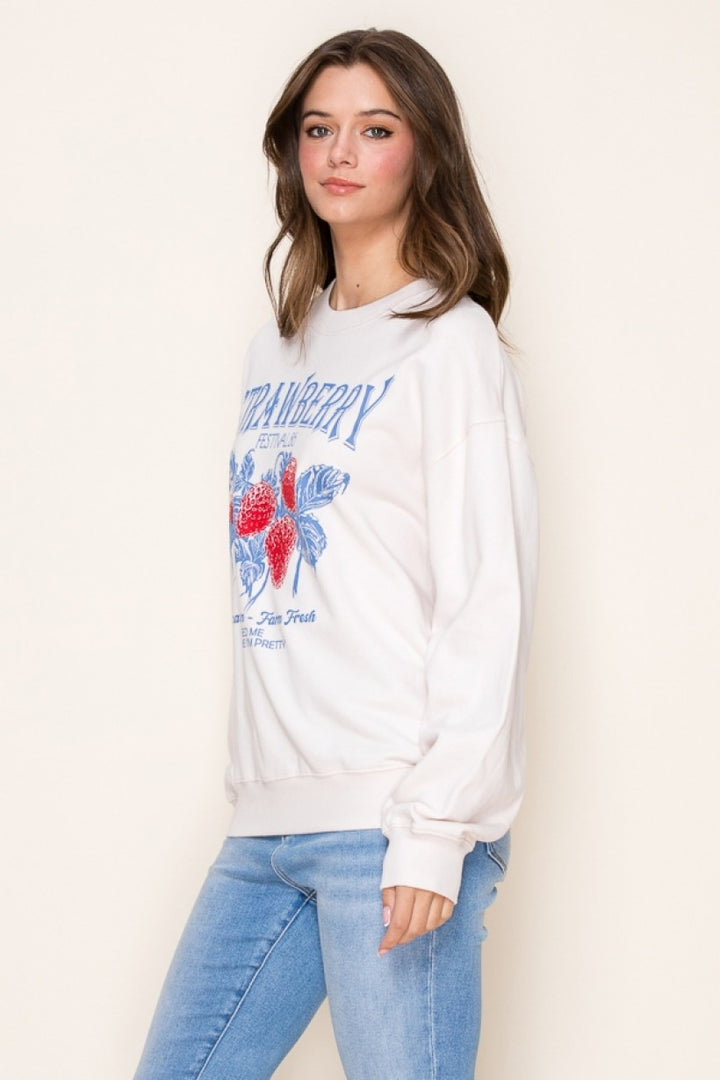 Side view of the Strawberry Festival Graphic Sweatshirt with a vibrant strawberry print, relaxed fit, and soft fabric for a trendy and playful look.