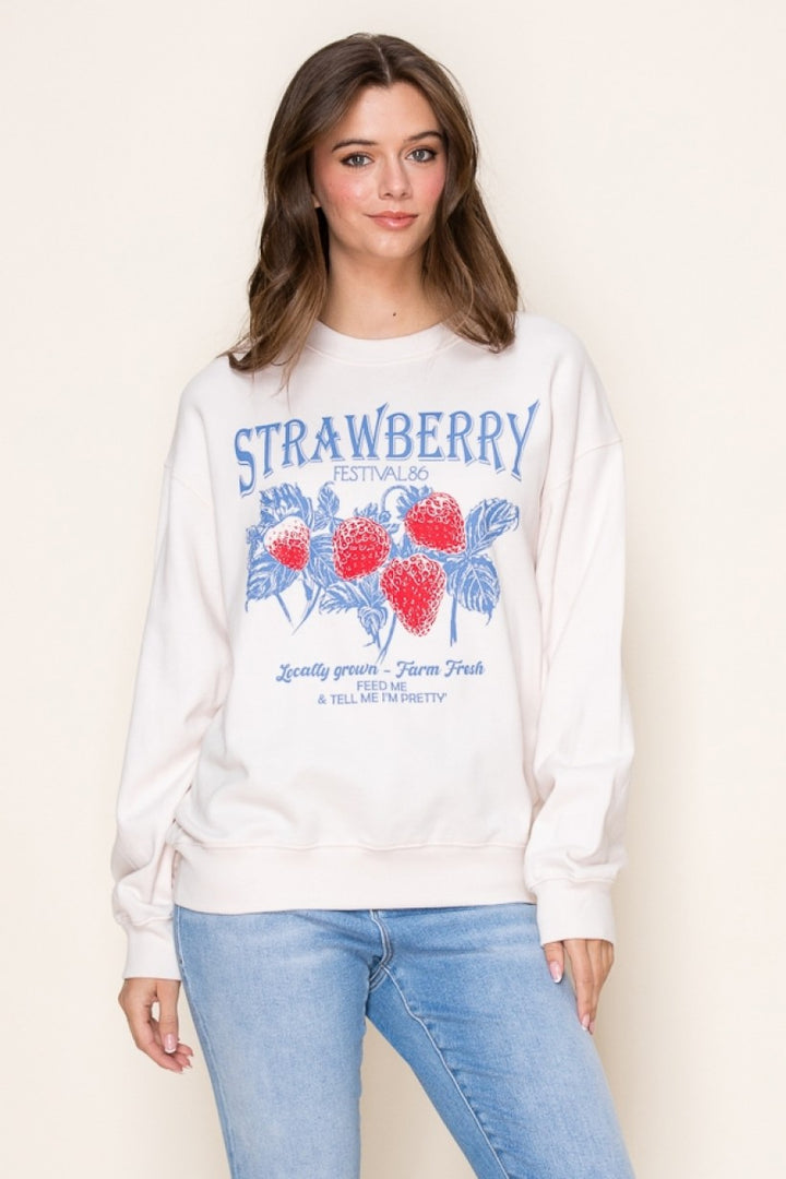 Front view of the Strawberry Festival Graphic Sweatshirt with a vibrant strawberry print, relaxed fit, and soft fabric for a trendy and playful look.