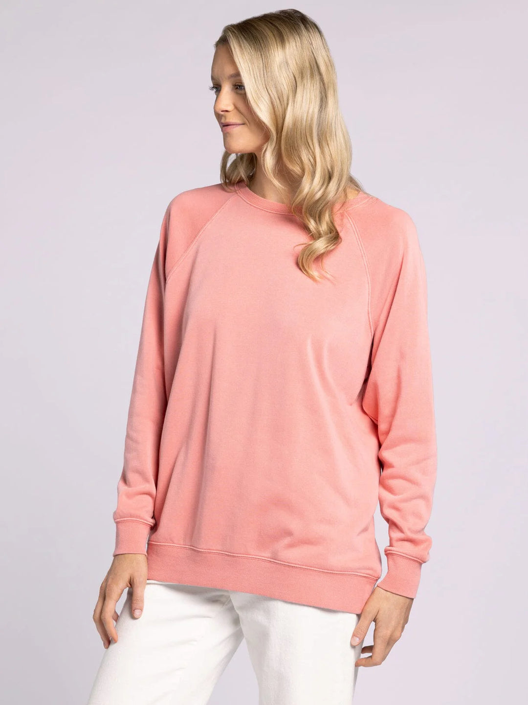 Soft and lightweight Thread & Supply Hangout Top in strawberry ice. Long sleeve crewneck with a relaxed fit, ribbed hem, and cuffs. Perfect cozy top for layering or everyday wear.