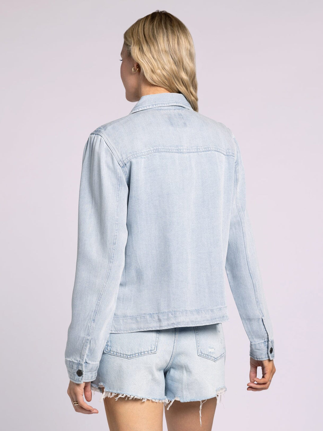 Back view of lightweight Thread & Supply Jackie Jacket in soft Tencel with button front and side pockets, styled as a versatile layering piece.