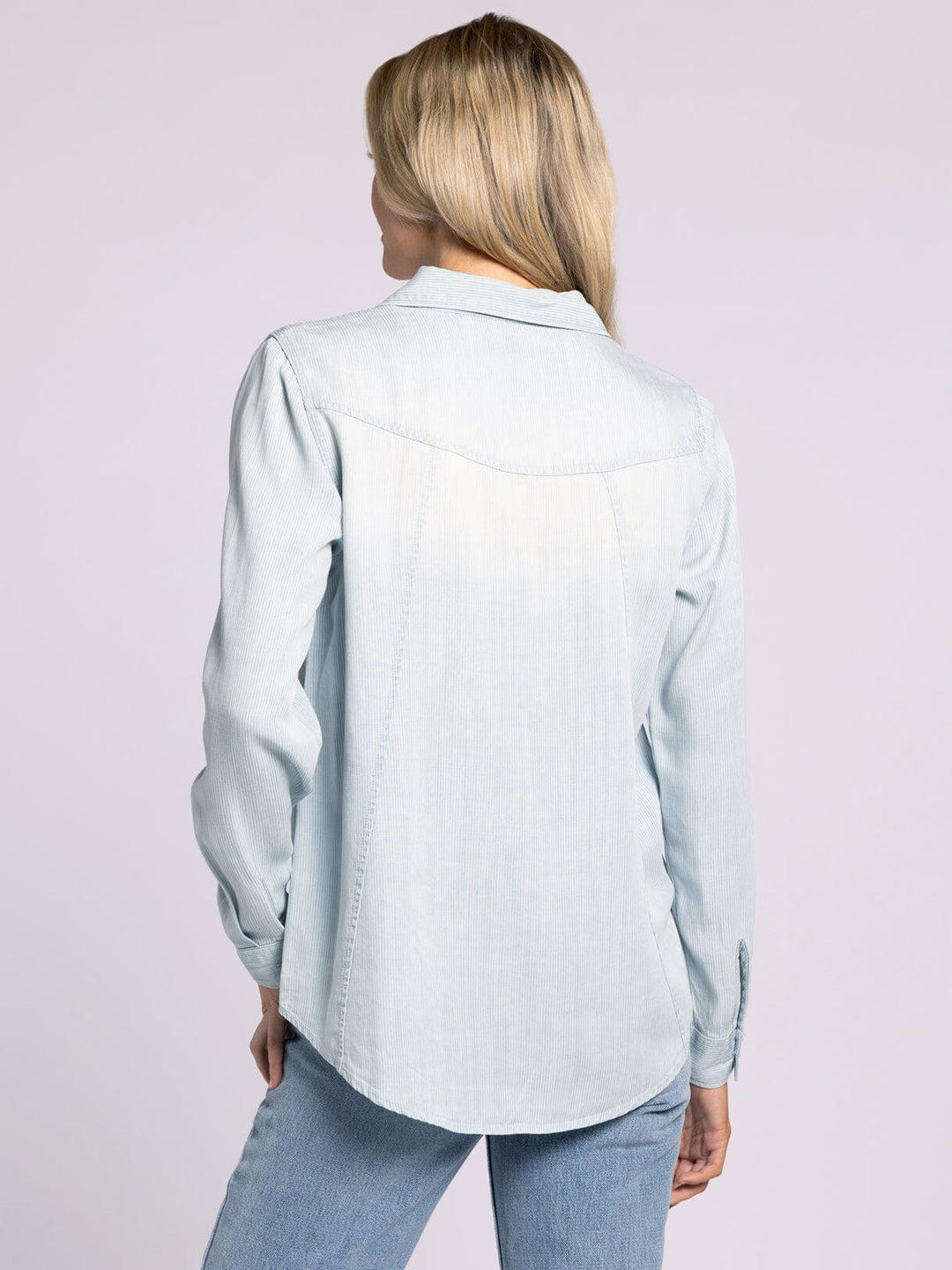 Backside view of the Ginger Mia Pinstripe Top by Thread and Supply in soft Tencel with a relaxed fit, button-front closure, and dual front pockets, styled for effortless layering.