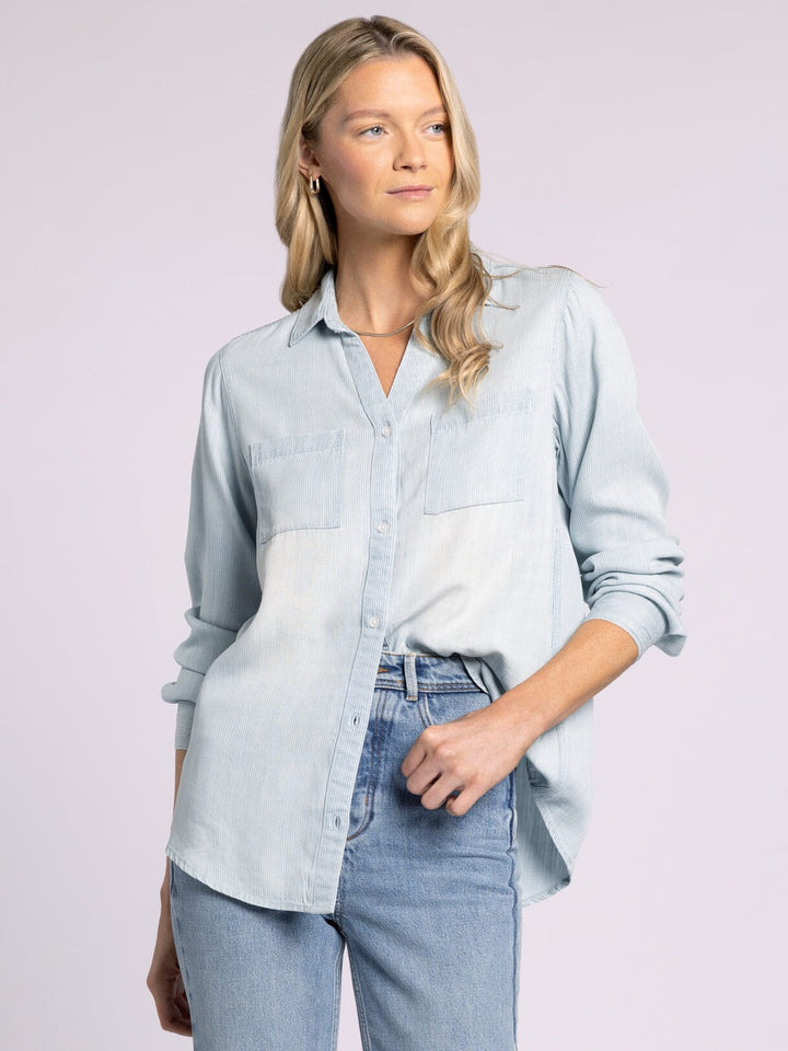 Ginger Mia Pinstripe Top by Thread and Supply in soft Tencel with a relaxed fit, button-front closure, and dual front pockets, styled for effortless layering.