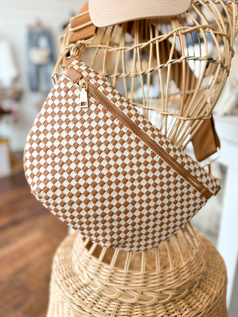Checkered brown and white woven Maddox crossbody belt bag with adjustable strap