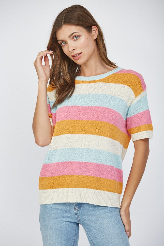 Woman wearing a short sleeve striped lightweight sweater in pink, blue, orange, and off-white
