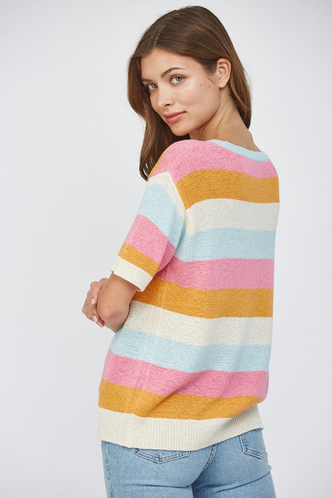 Woman wearing a short sleeve striped lightweight sweater in pink, blue, orange, and off-white