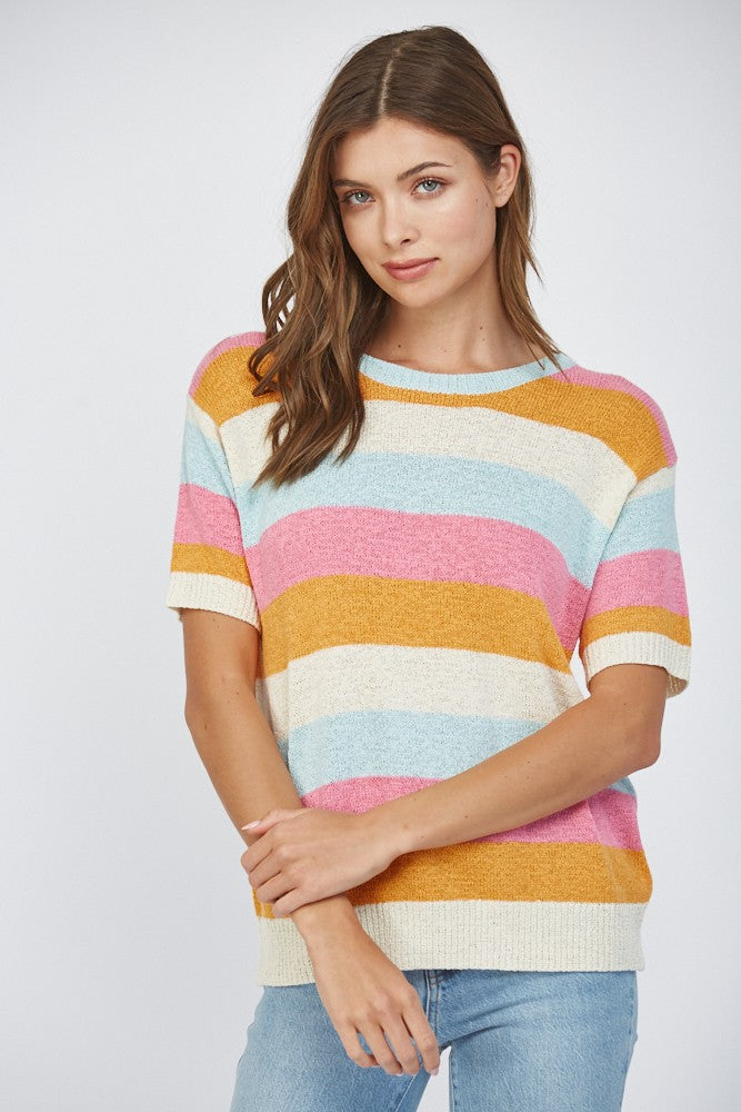 Woman wearing a short sleeve striped lightweight sweater in pink, blue, orange, and off-white