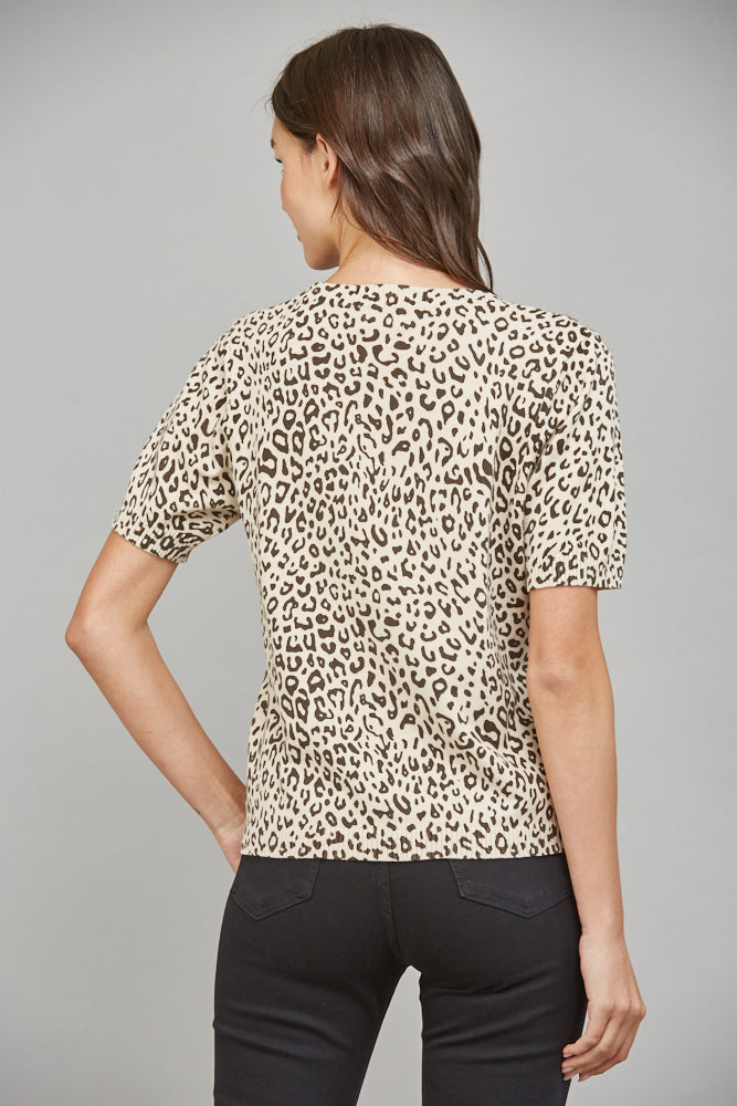 Back view of woman wearing taupe and black animal print short sleeve cotton sweater