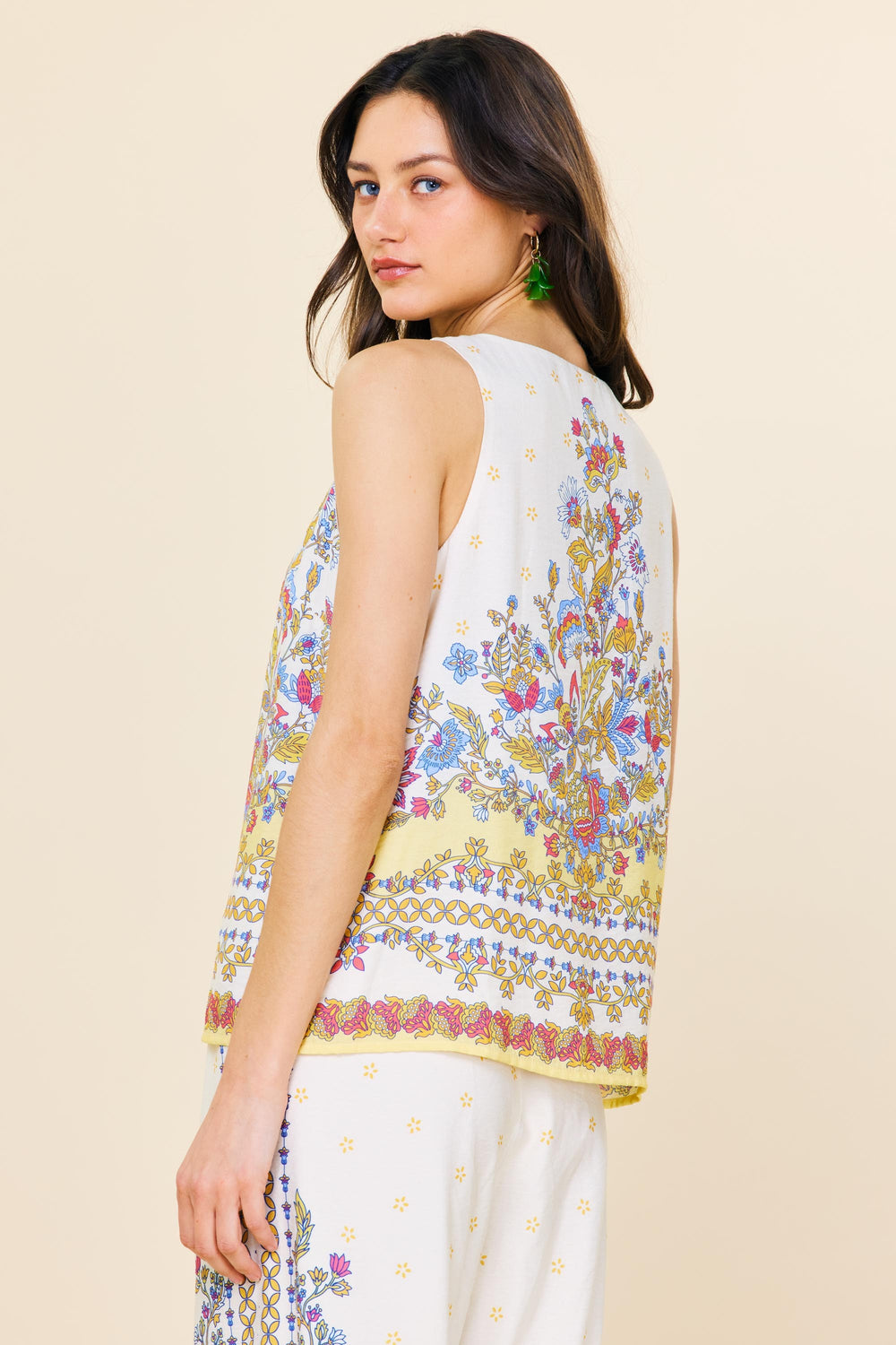 Back view of Skies Are Blue sleeveless multicolor border print top with buttons and lining